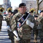 Staff Sergeant Jeff Kazmierski, 484th Army Band, leads a former Vets Day Parade; image for a Veterans Day 2022 blog post